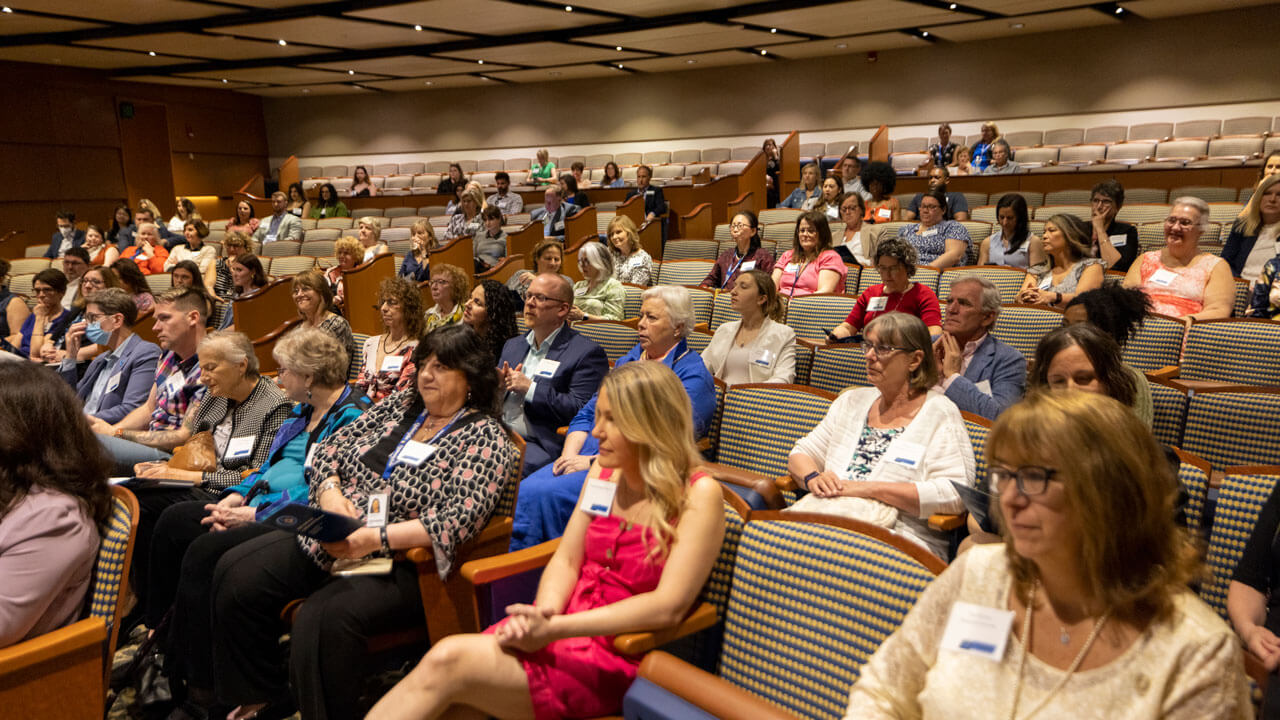 Attendees listen to speaker