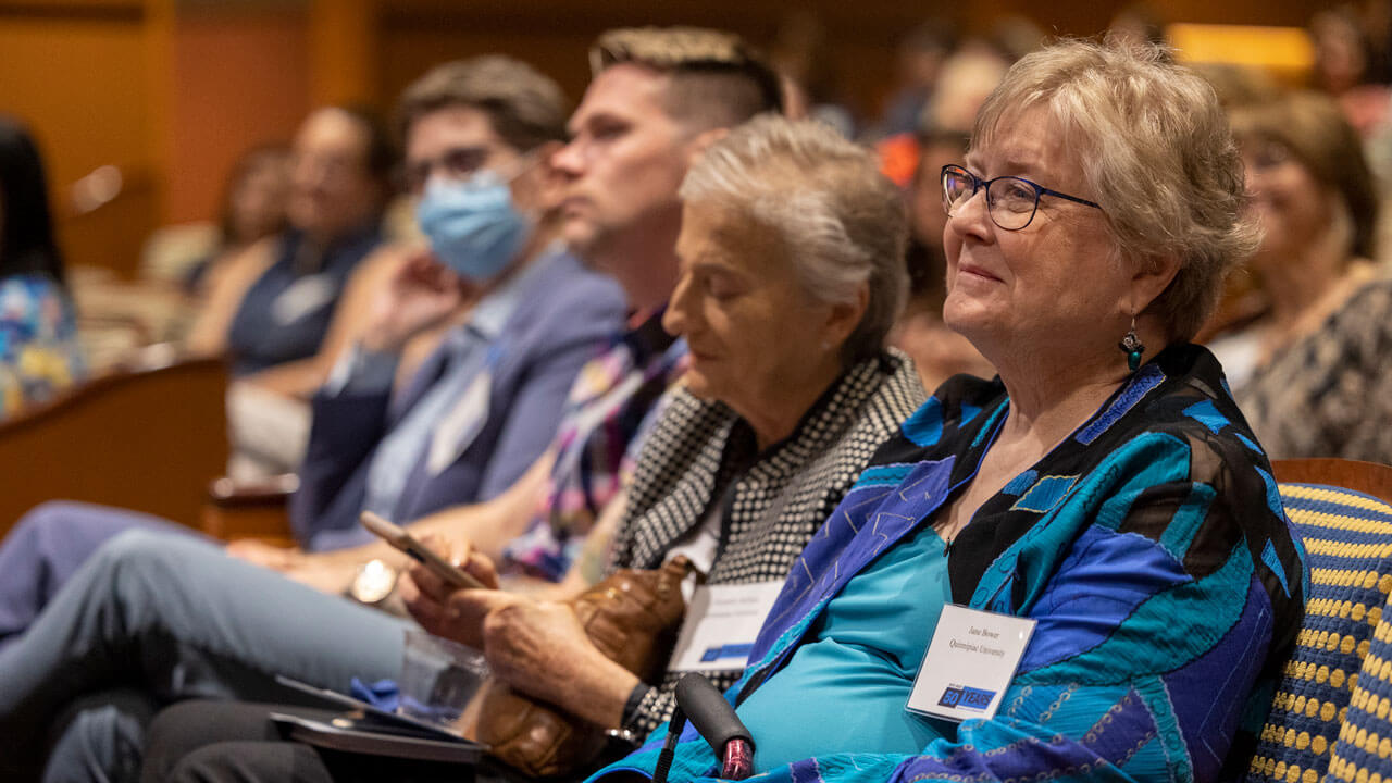 QU Alumni listen eagerly to speakers