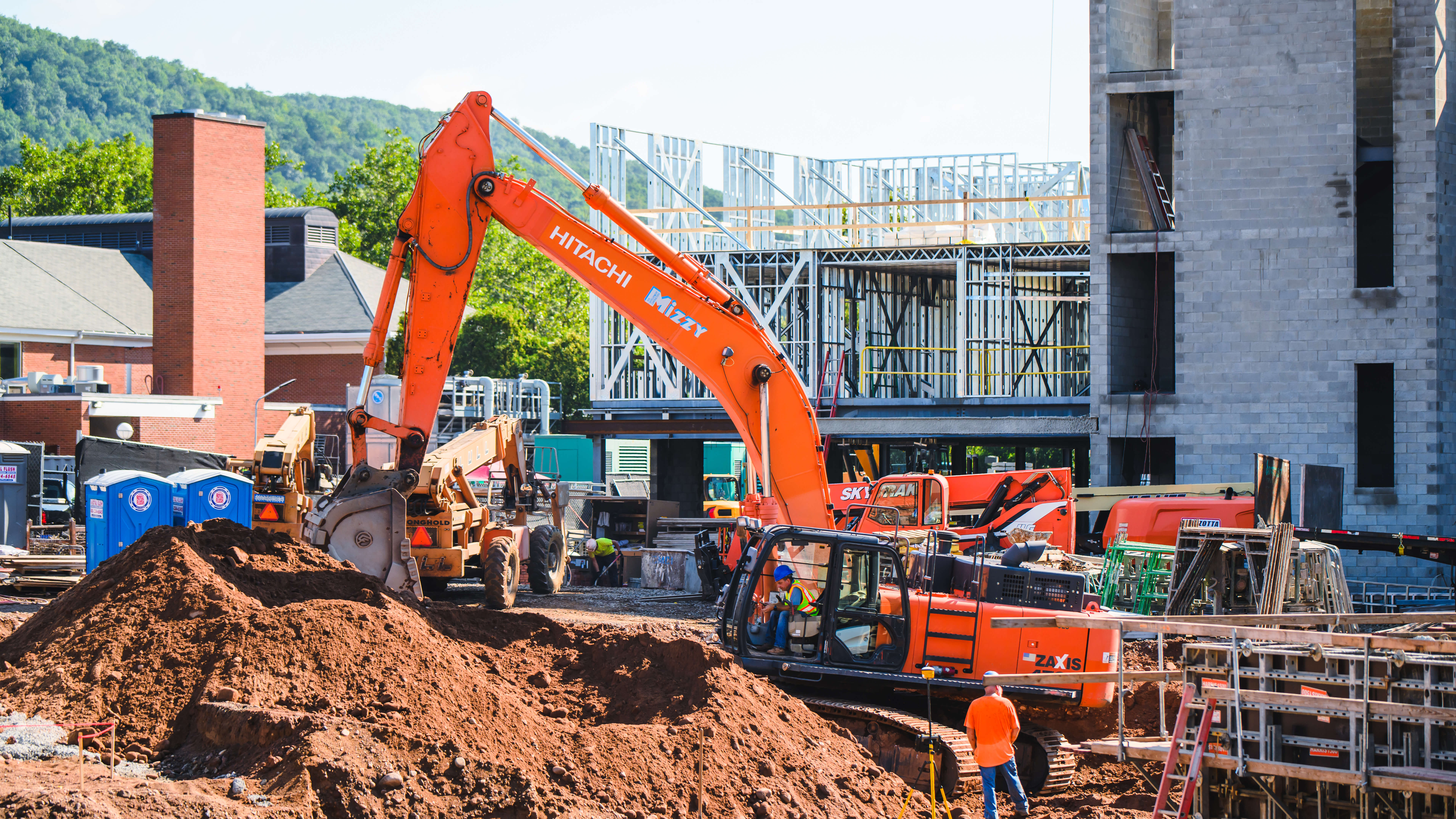 Excavator scoops dirt out of a hole