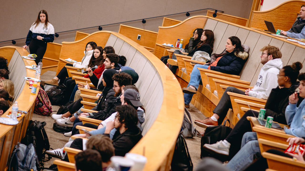 An overhead photo of dozens of students sitting in the Mount Carmel Auditorium.