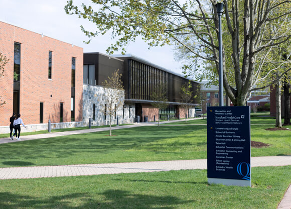 Outside of the Recreation and Wellness Center with a sign pointing to the Hartford HealthCare services