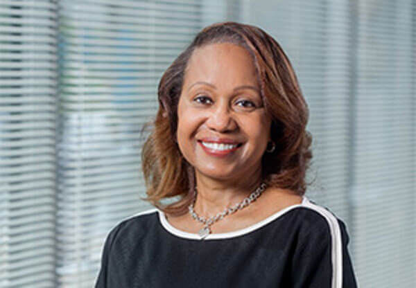 Terri Estes smiles for a headshot.