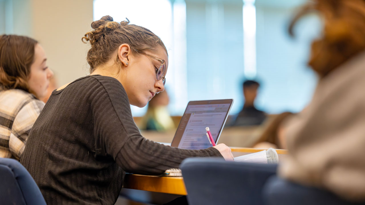 A female student taking notes