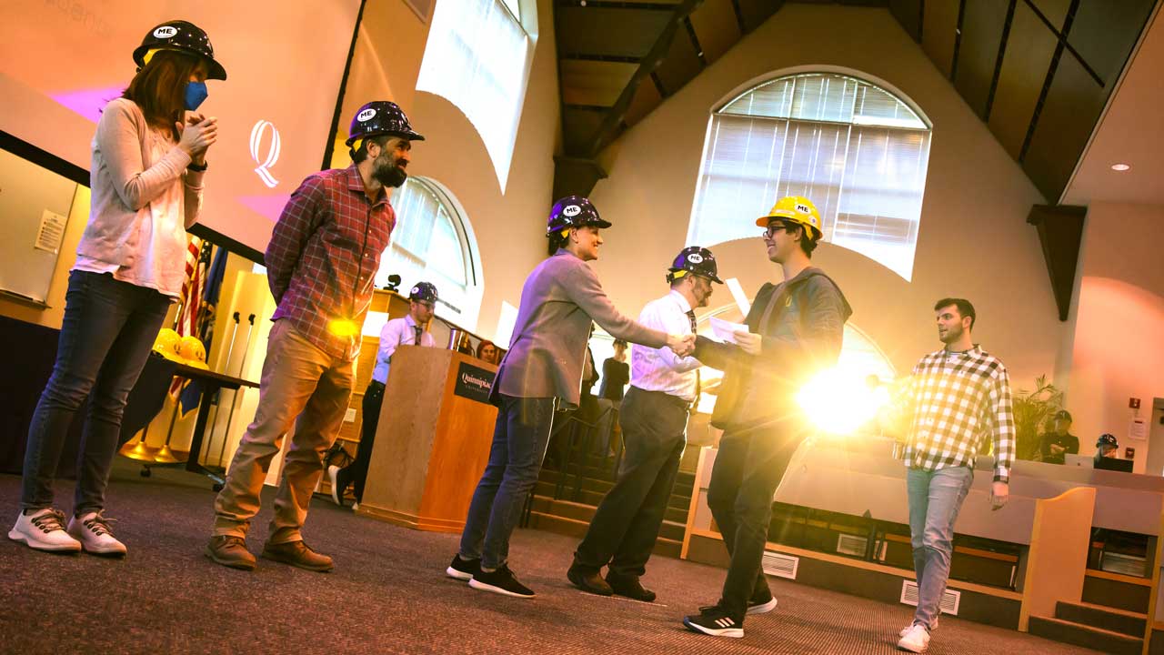 A group of students in line to receive their hard hat