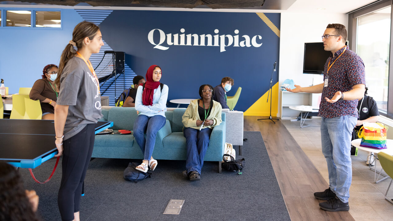 QUADS students play ping pong with their mentors at the Quinnipiac North Haven campus.