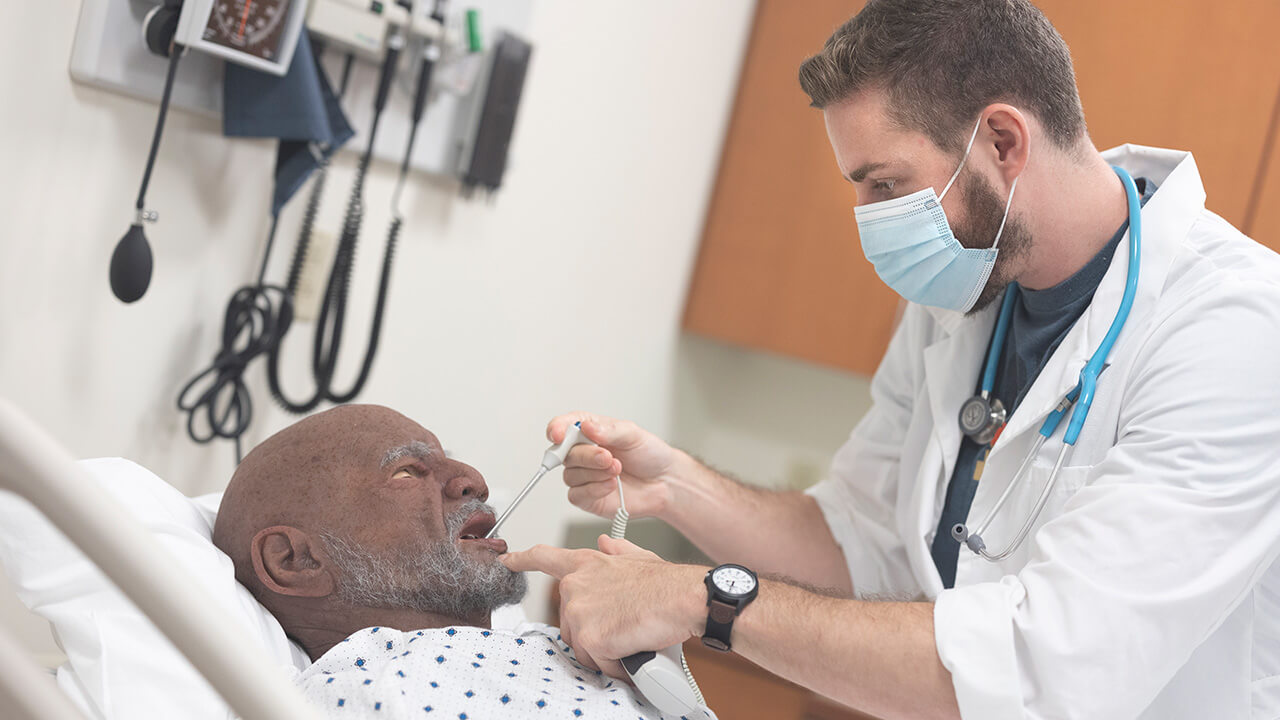 Students in Quinnipiac University’s accelerated nursing program conduct a patient assessment on high-fidelity mannequins that are equipped with echo masks to represent different races, ethnicities and age populations.