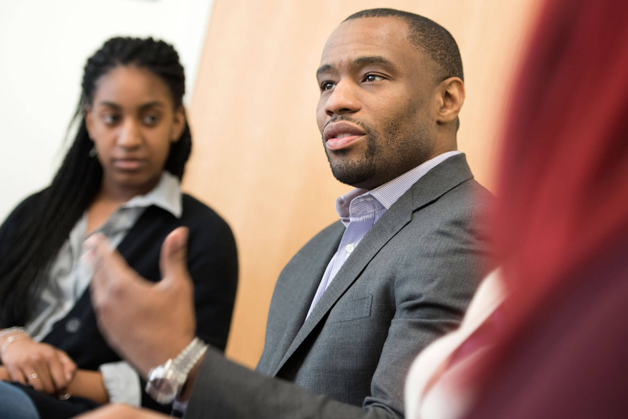 Marc Lamont Hill speaks to a handful of guests during a reception.