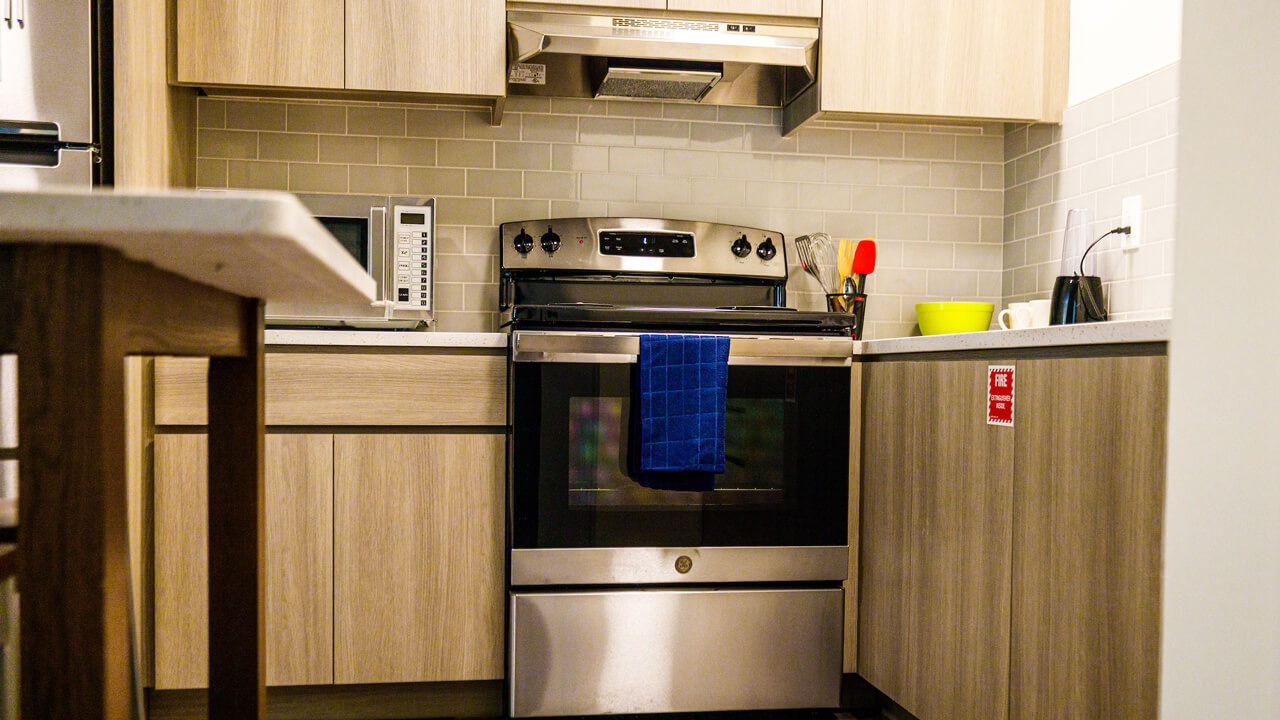 Kitchen with stainless steel stove, oven, and microwave