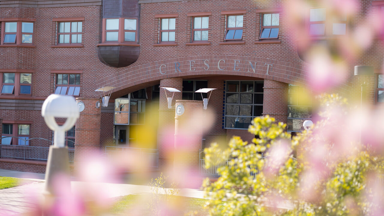 View of the Crescent entrance with spring flowers in the foreground