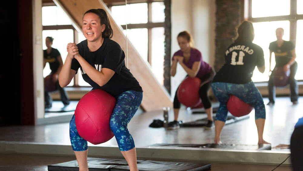 Quinnipiac student Anna Kohli teaches an Ugifit class in the Rocky Top fitness center