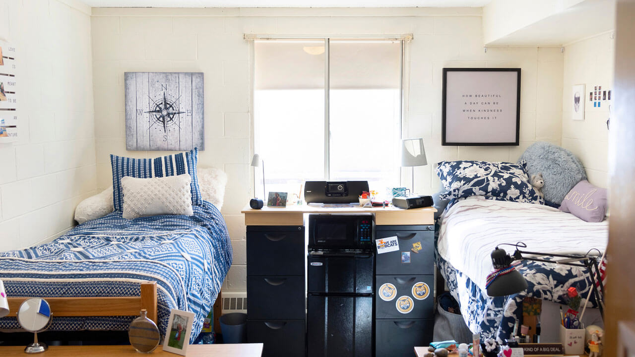 Blue themed double bedroom with 2 beds, 2 wardrobes, 2 desks, and 2 chairs