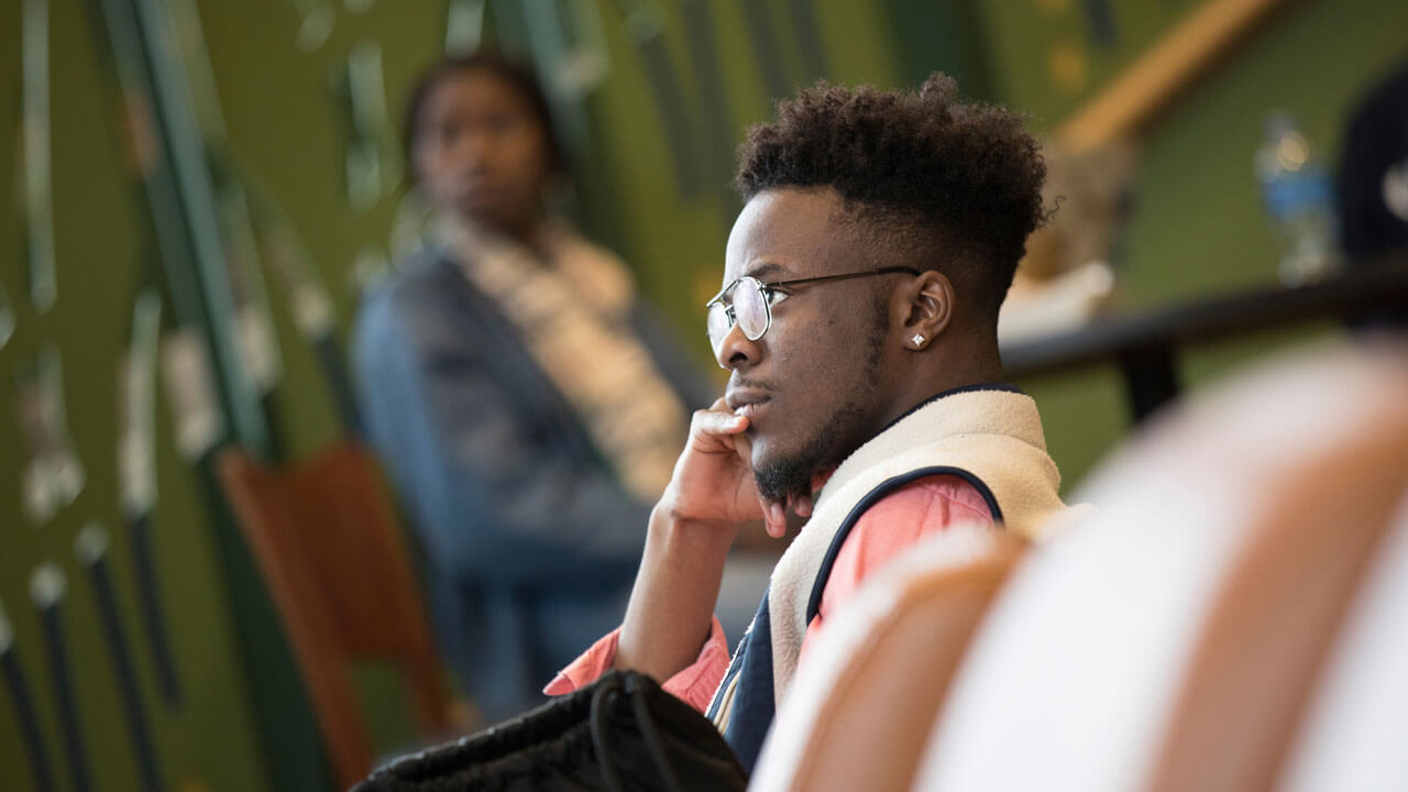 A student listens thoughtfully during the teach in event