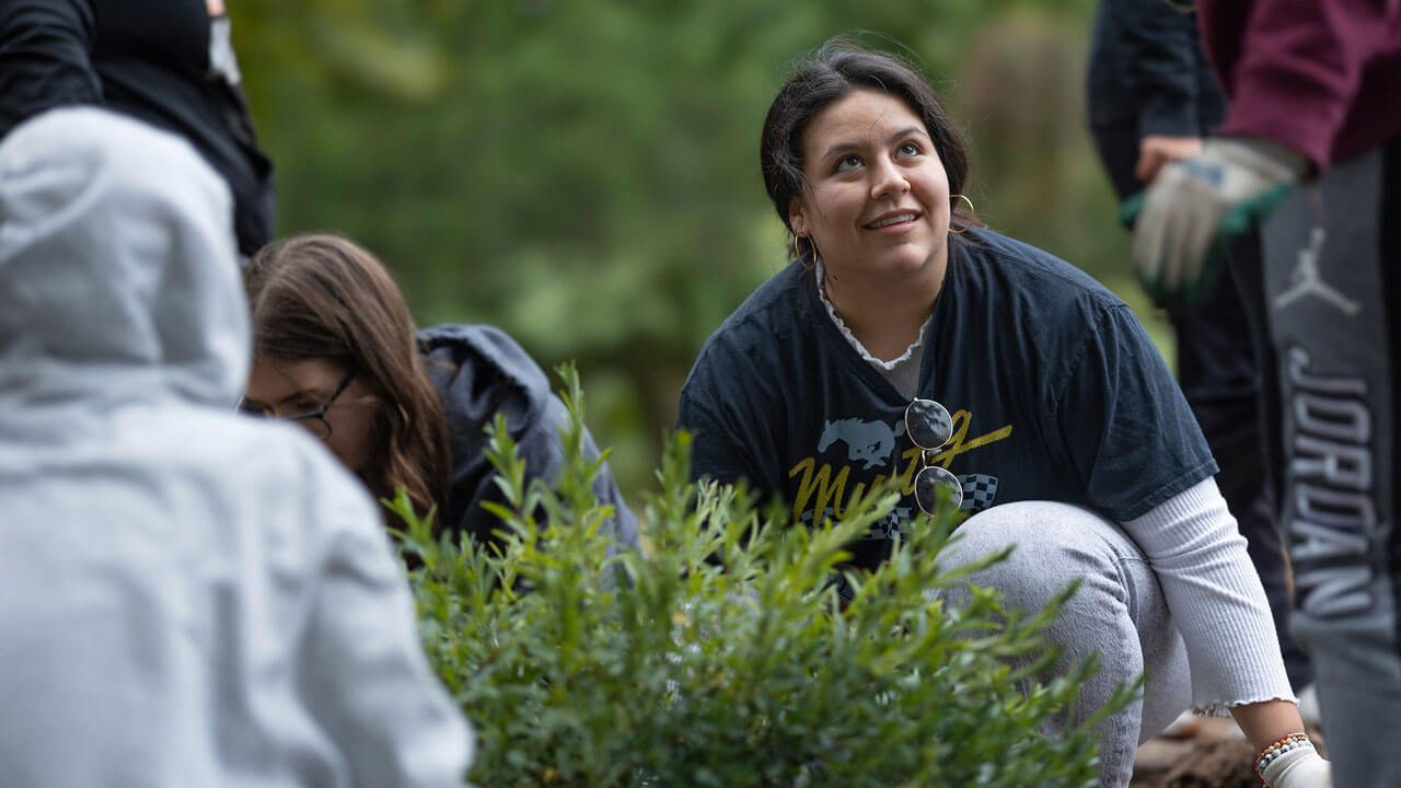 Students planting greenery.