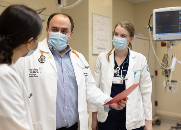 Three doctors standing and talking