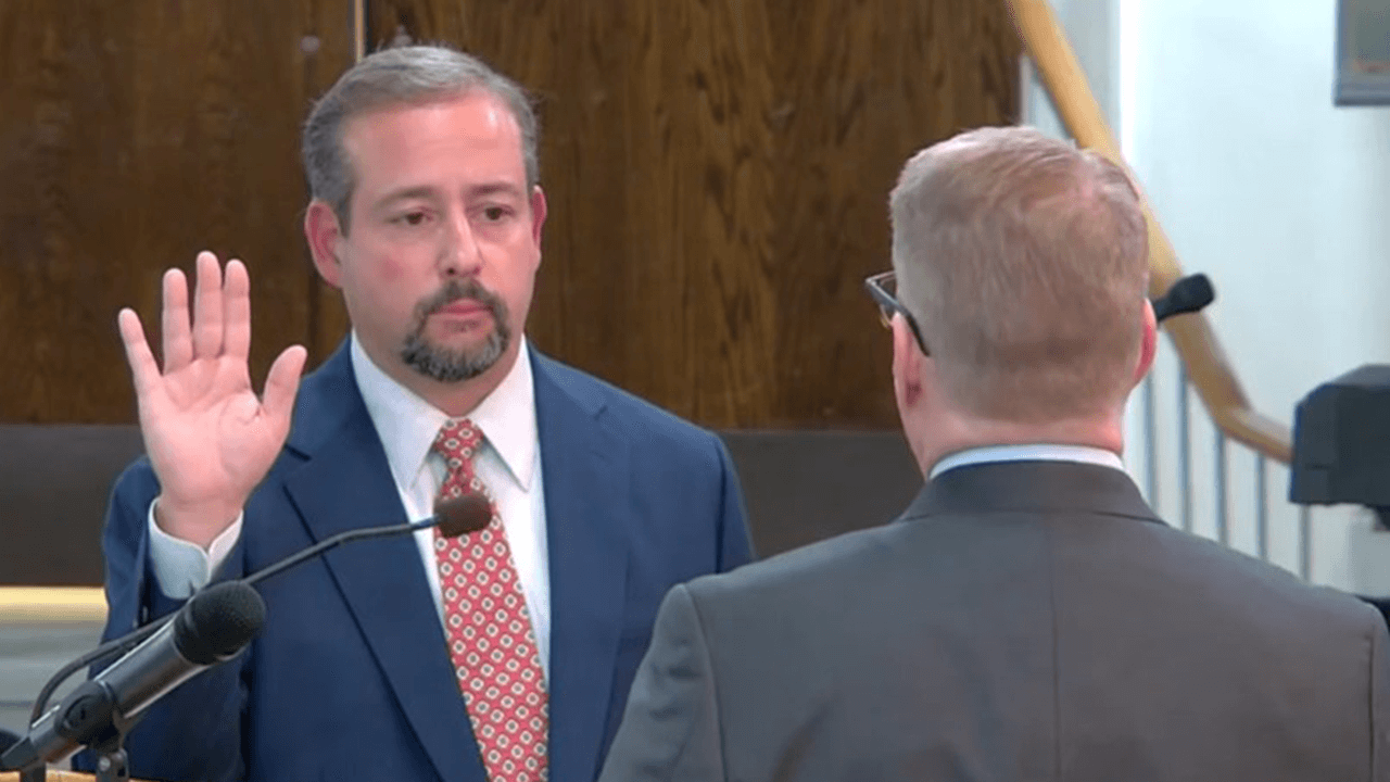 Mayor Vincent Cervoni raises his right hand as he is sworn in as mayor.