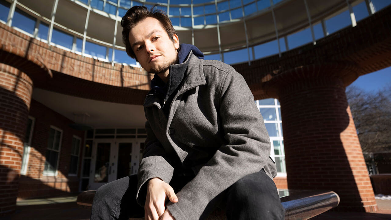 Jack Ebert sits outside the Lender School of Business Center