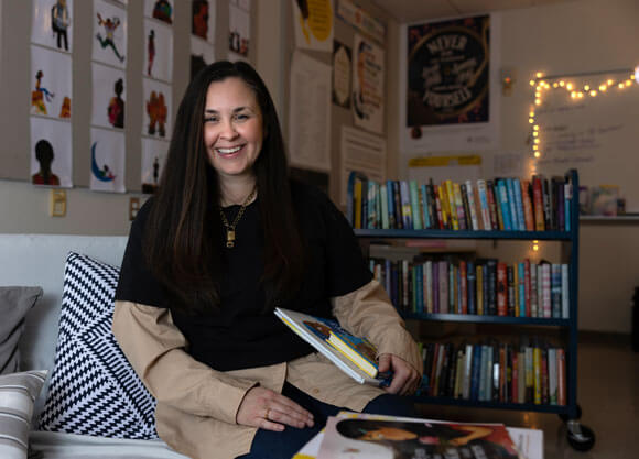 Kara Breen poses with a selection of books from her new anti-racism literature course