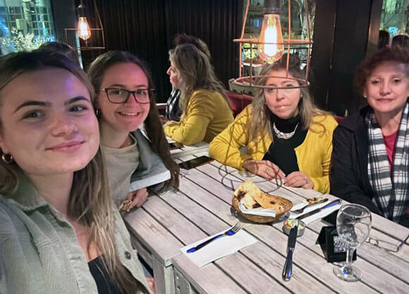 Aliana Castro sitting with a group of colleagues