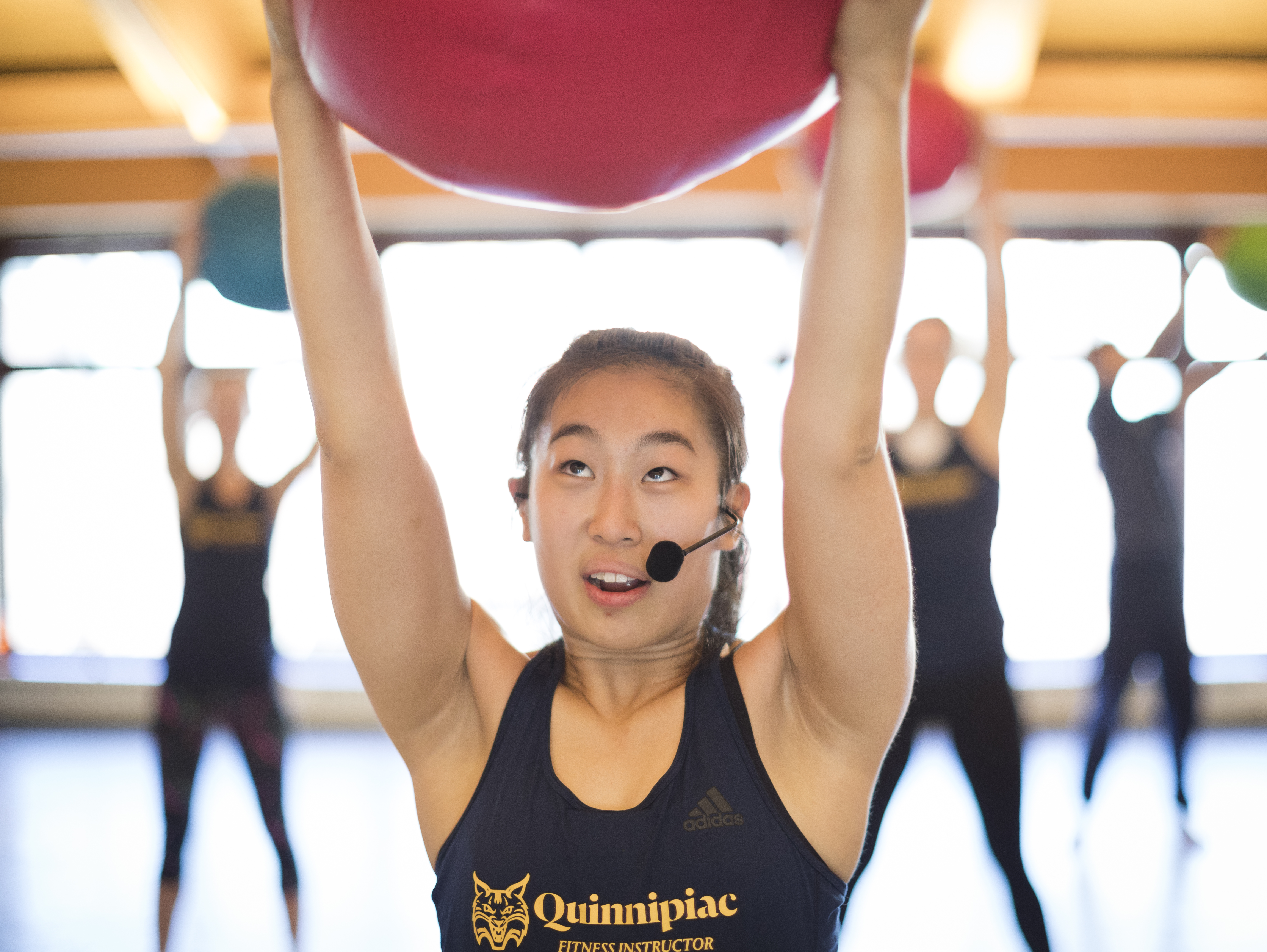 Girl with yoga ball over head