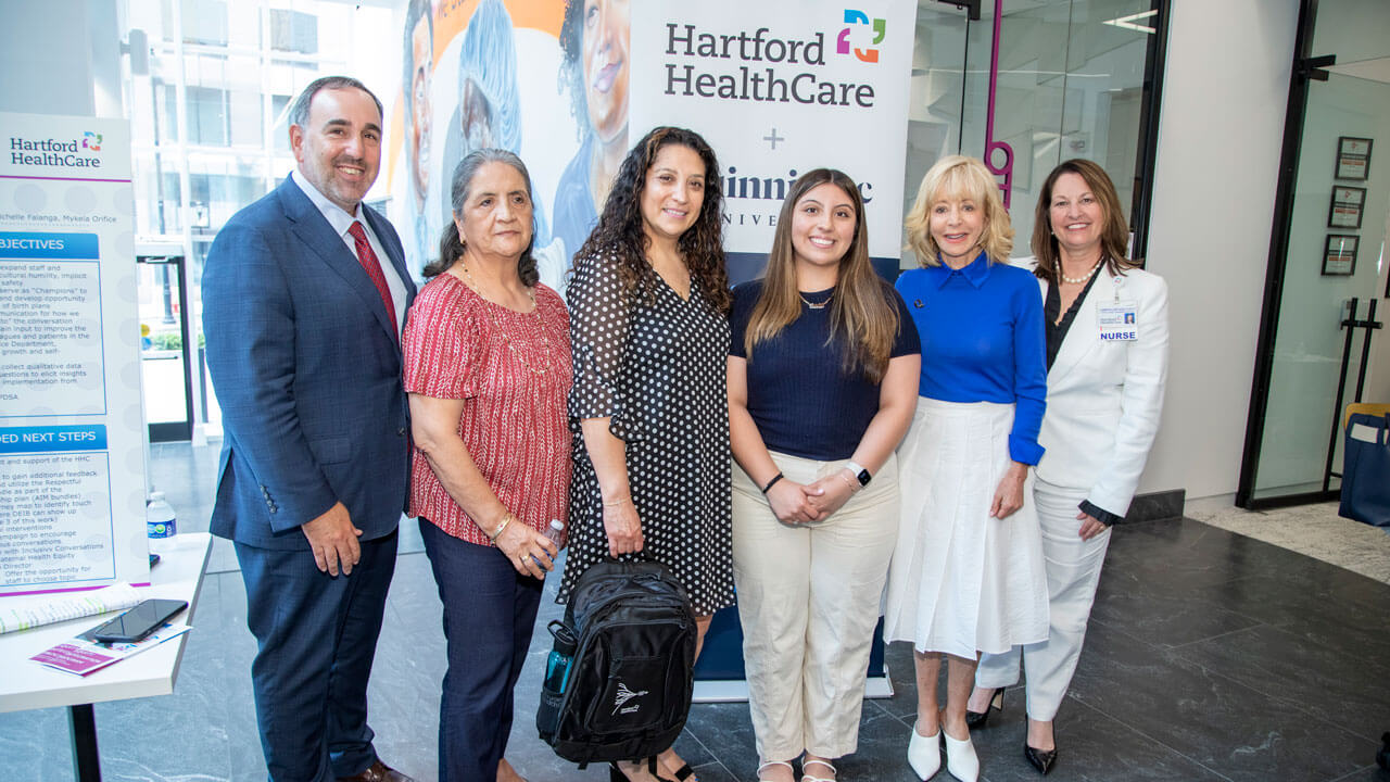 President Judy Olian smiling and taking photo with first-years family