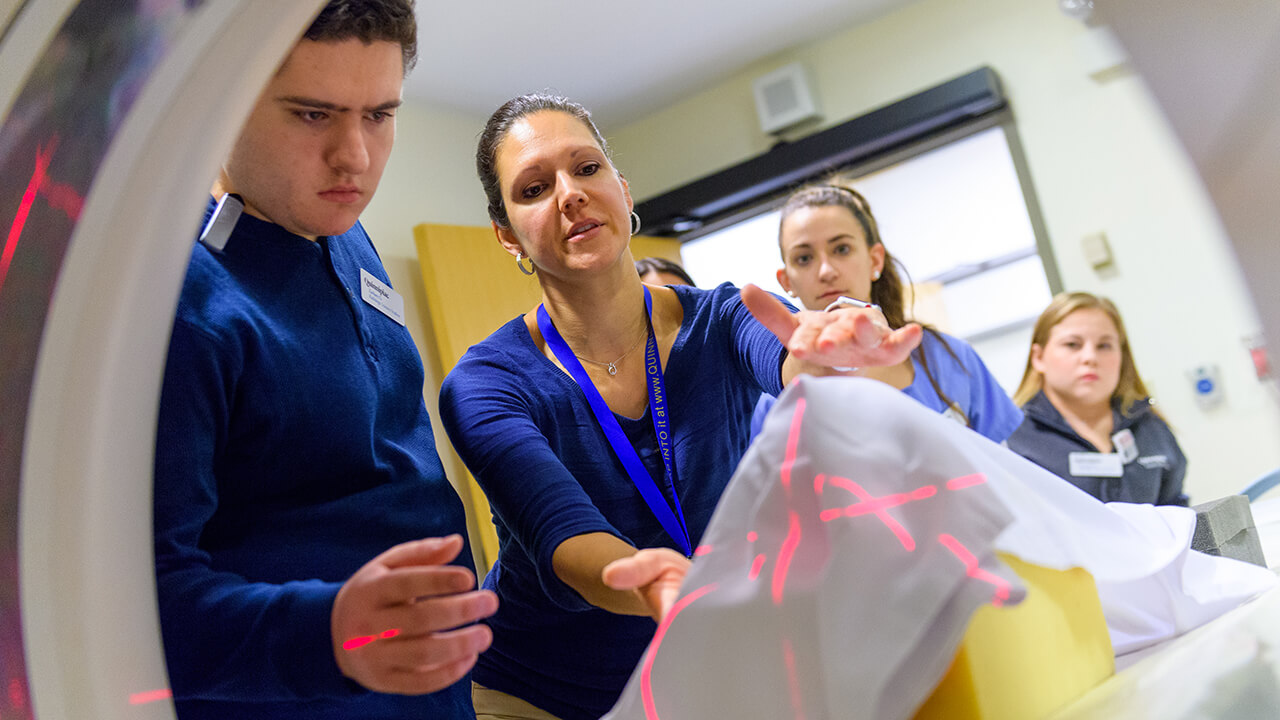 Tania Grgurich works with students on an MRI.