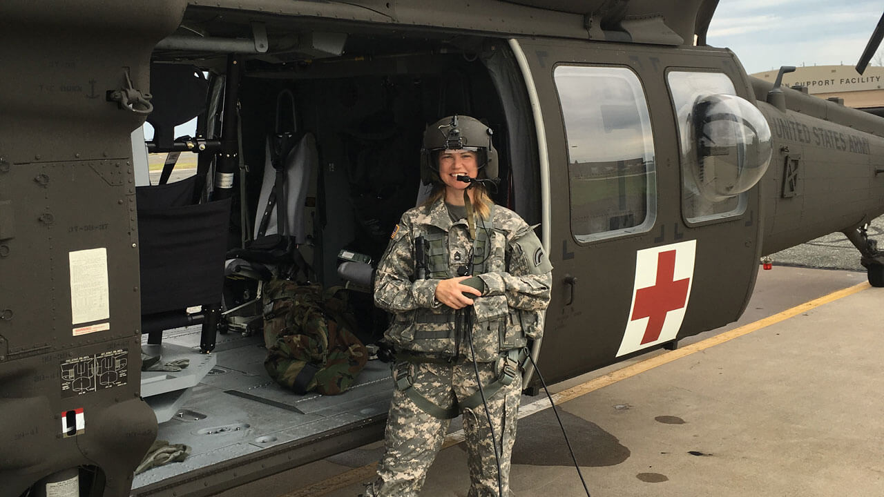 Stefanie Trouern-Trend in uniform in front of a helicopter.