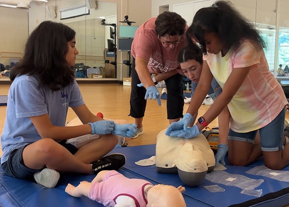 Students perform CPR on CPR mannequins