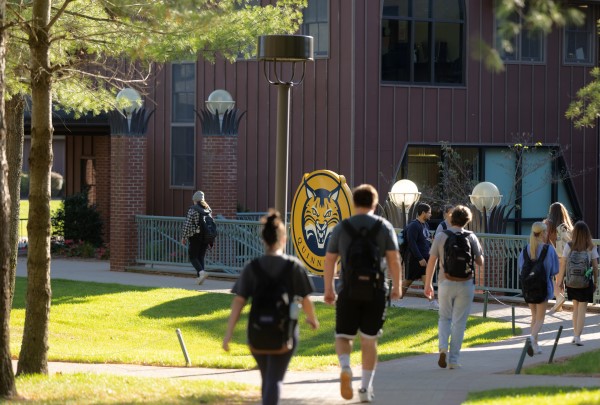 Photo of students walking outside of the College of Arts and Sciences