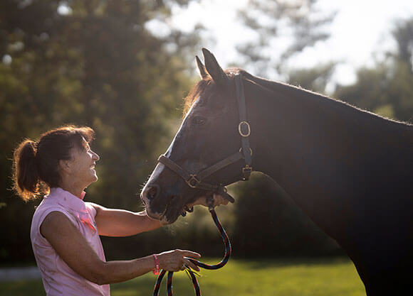 Professor Donna Latella pets a horse