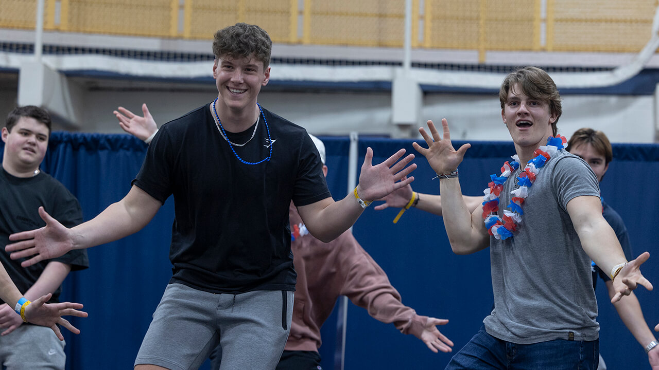 Boys dancing with jazz hands at QTHON