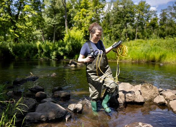 Joanna Kinsey stands in the river