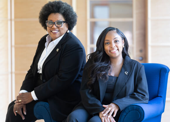 Cheri Brooks sits to the left of Briona Grant