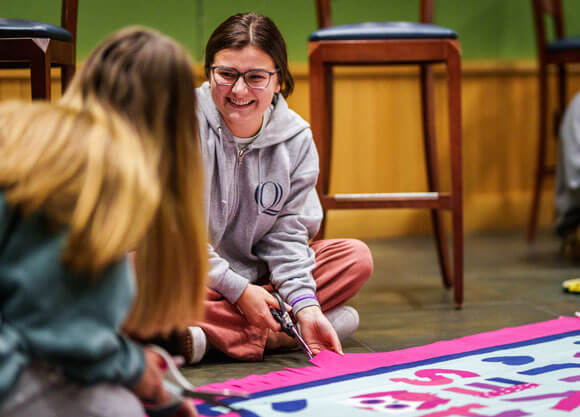 Two QSNA students make a blanket for Connecticut Children's Medical Center.