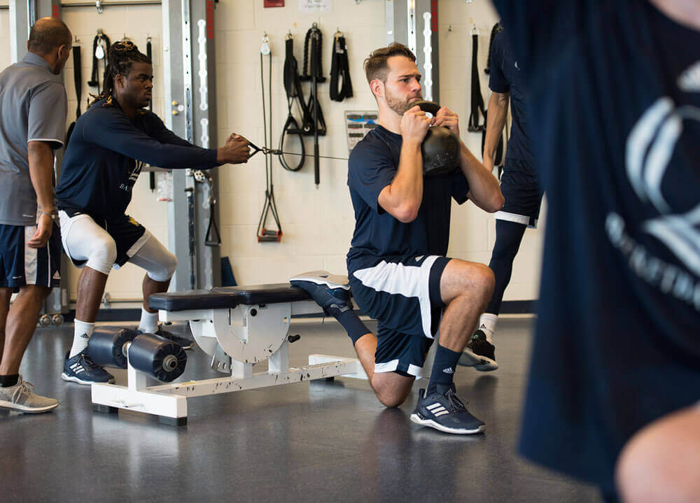 Quinnipiac men's basketball player lifts weights