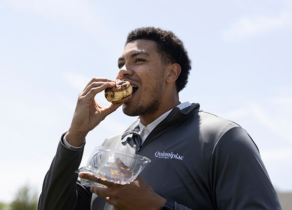 A man eats an ice cream treat.