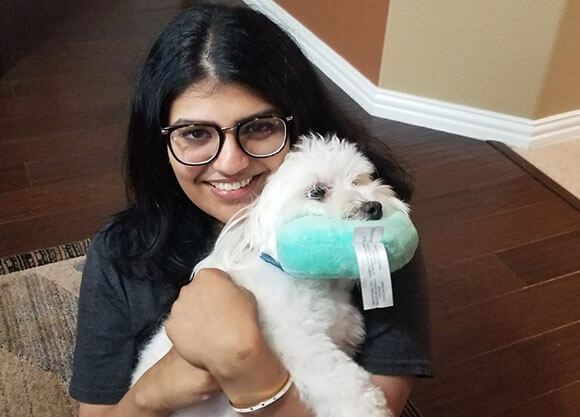 woman holding a white dog