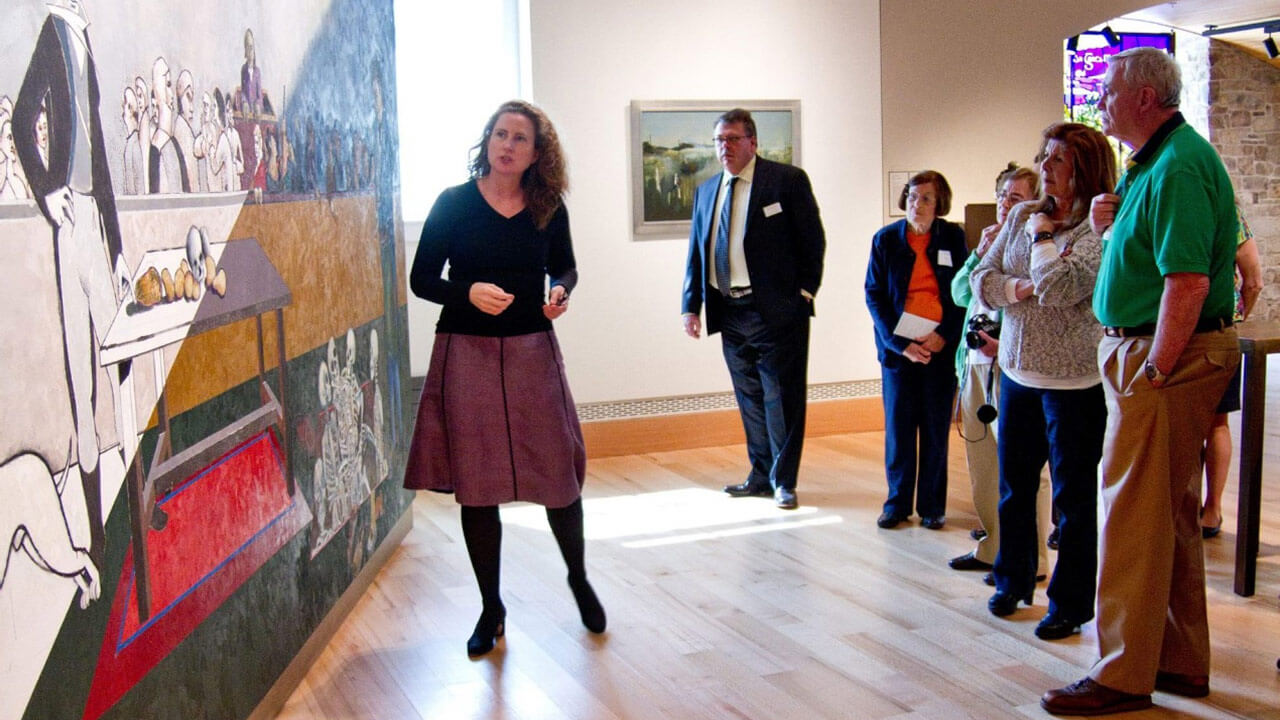 Grace Brady, left, executive director of Ireland’s Great Hunger Museum at Quinnipiac University, leads a museum tour.