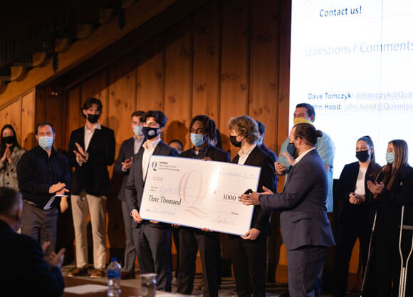 Students holding $3,000 check prize and taking group photo