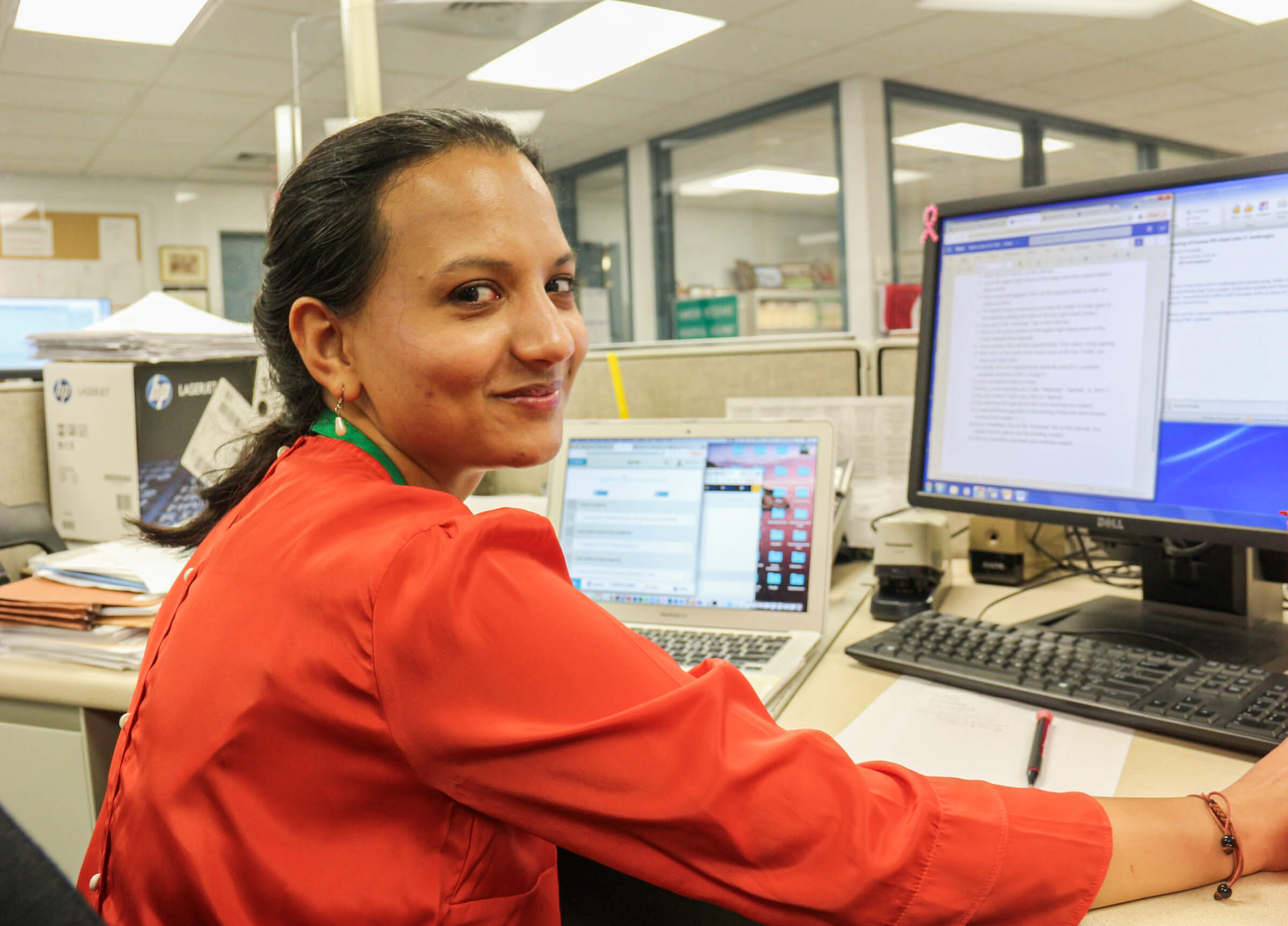 Public Service Fellow Manavi Jain at her desk in the Town Clerk Office in Hamden