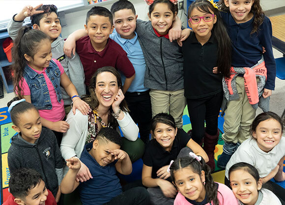 Teacher surrounded by students