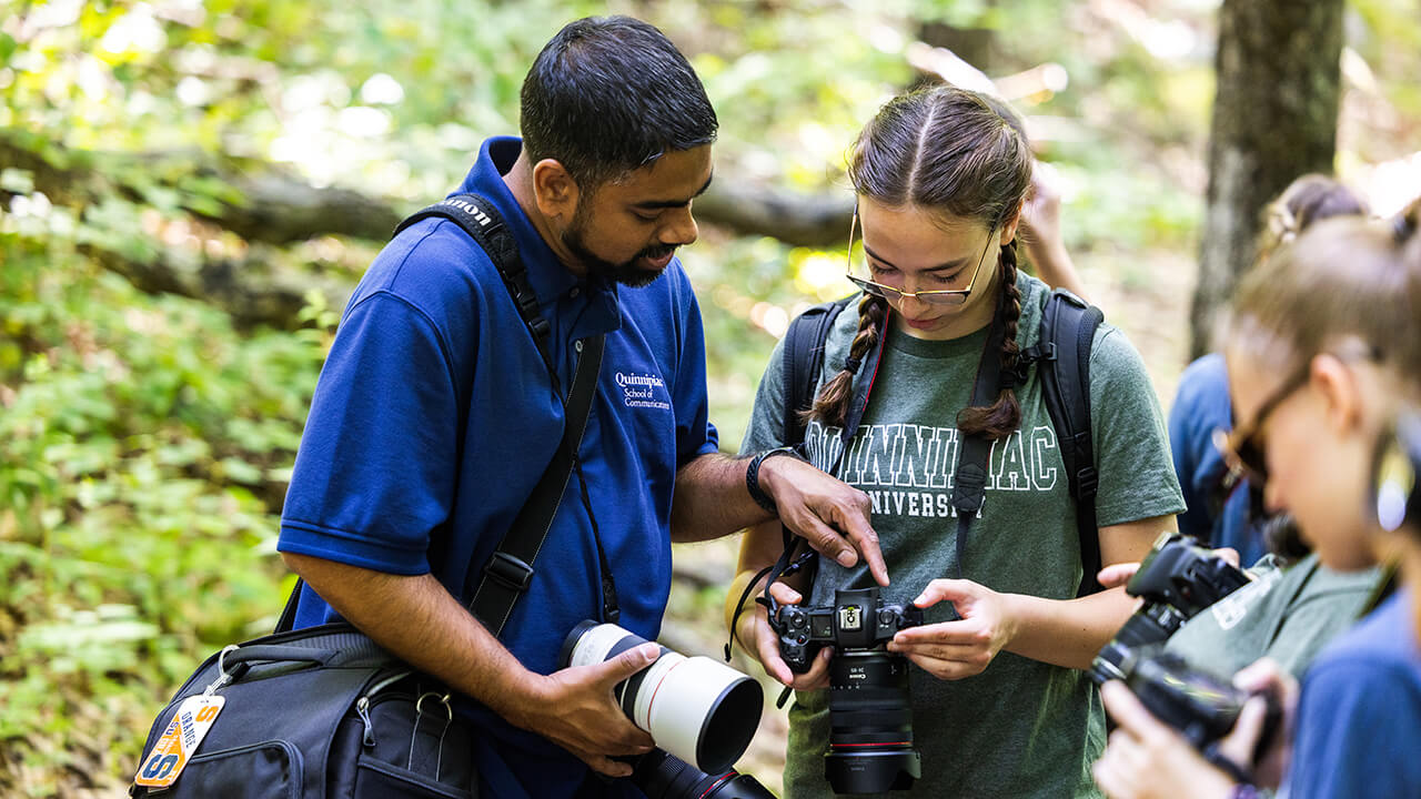 Students shoot photos as part of a summer camp.