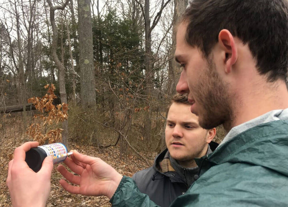 Two Quinnipiac students take measurements