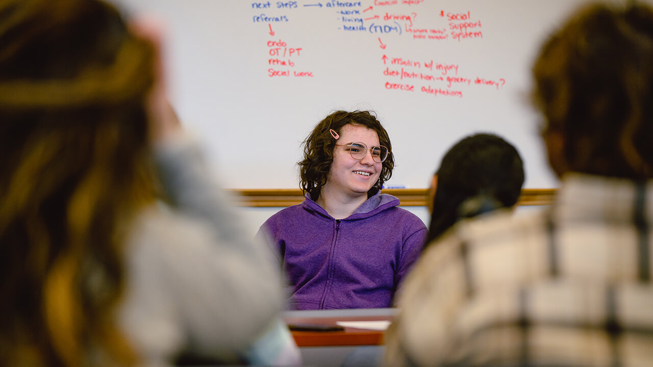 Presenter in classroom talking to students