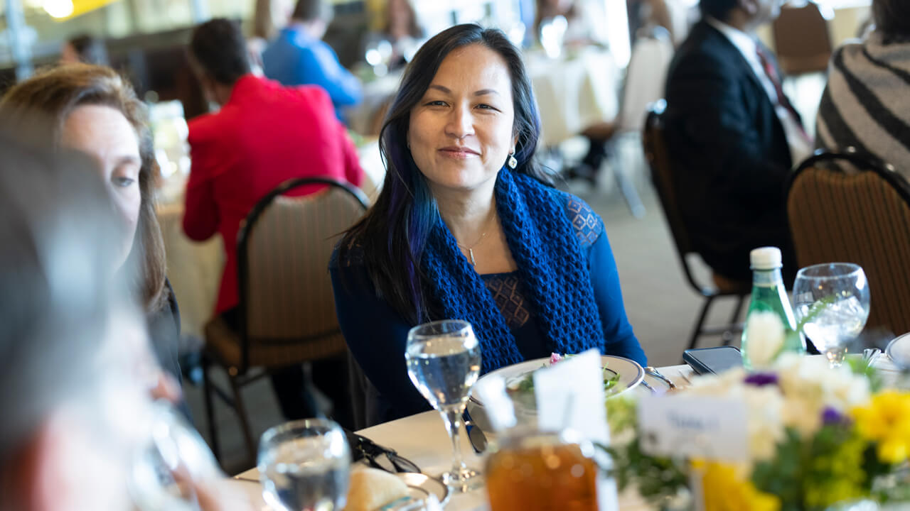 Attendees at the People's United Center for Women and Business listen to various speakers in the University Club