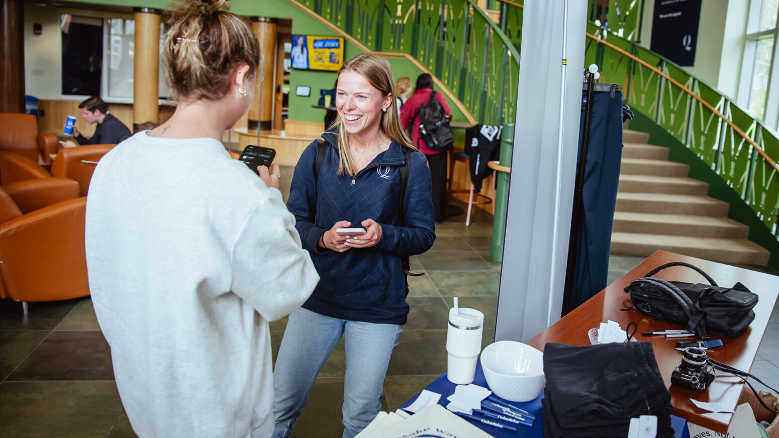 A student shops at the SEAAV pop up shop in the piazza.