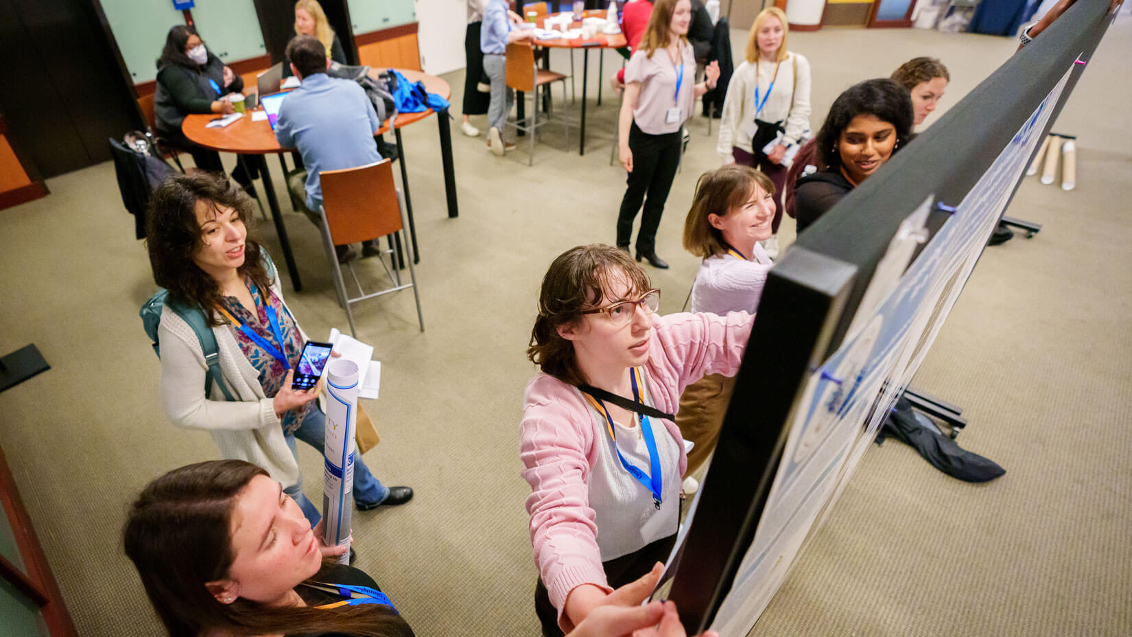 A student sets up their poster presentation at the NEURON conference.