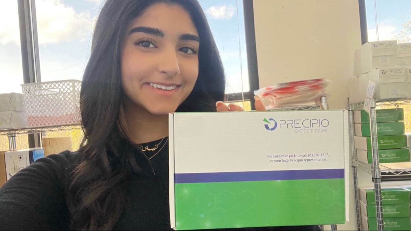 Tiana Hayek holding a specimen collection kit.