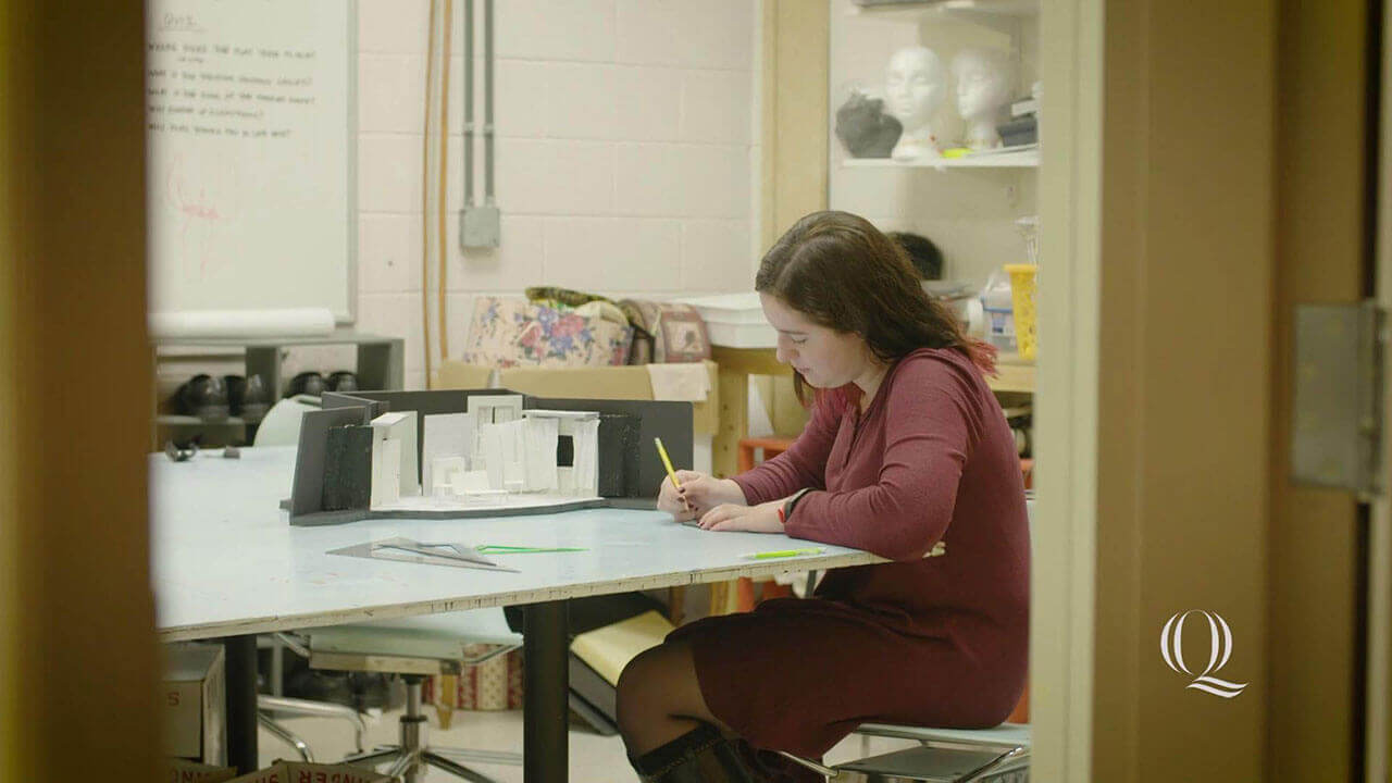 Cece Fanning sitting at a desk, writing, starts video