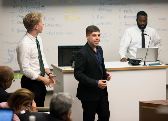 Entrepreneur major Mark Martino presents to a panel of judges in the Quinnipiac School of Business