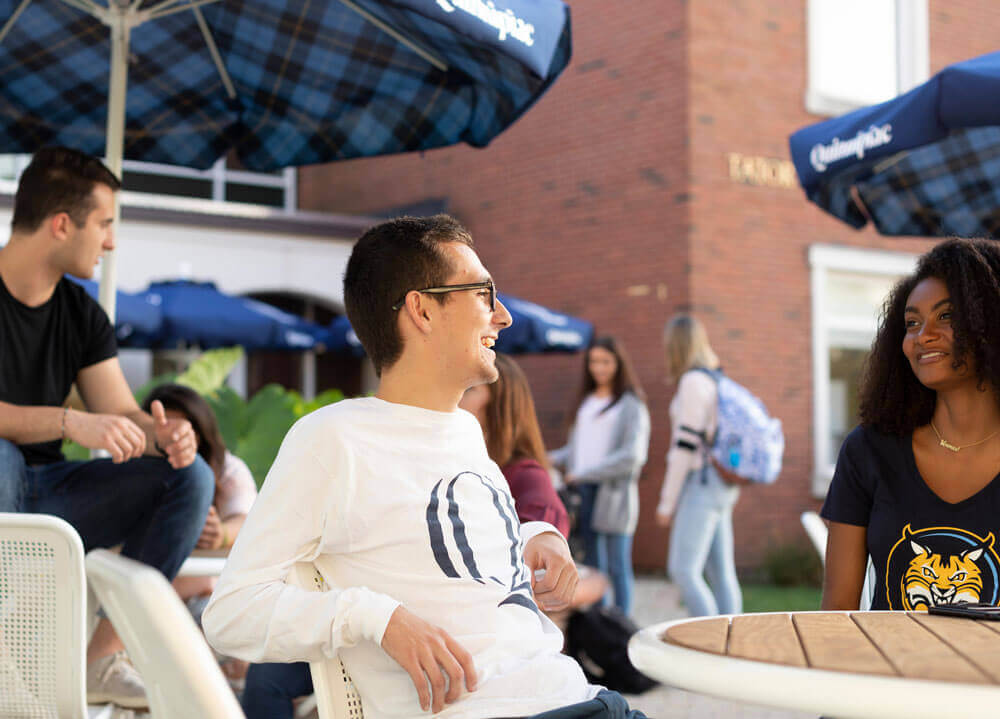 A group of students sitting and talking outside